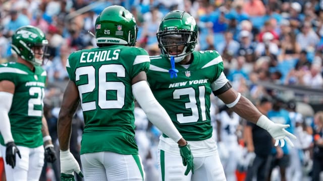 Craig James (31) and Brandin Echols (26) in an NFL Preseason against the Panthers